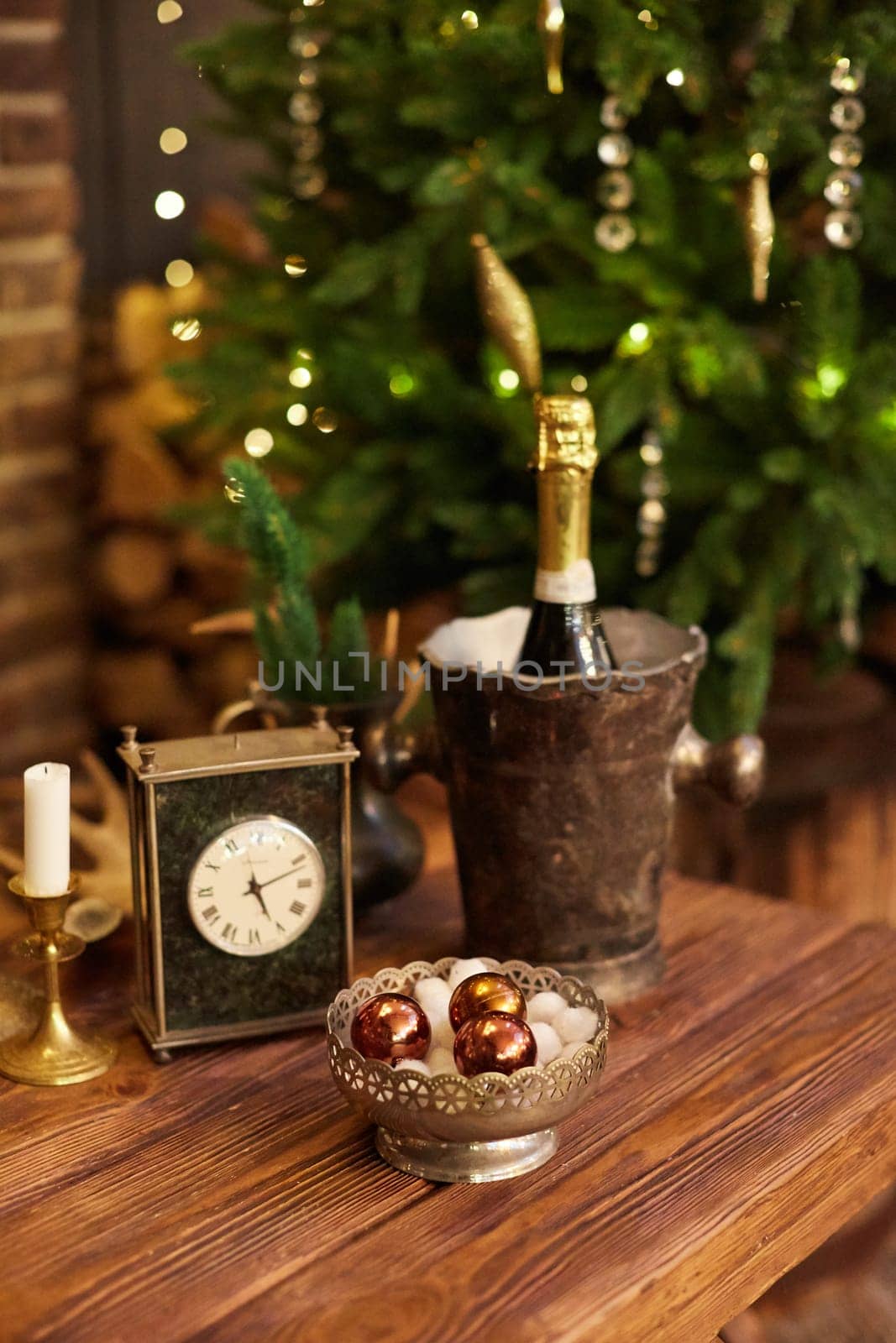 Home Christmas decoration interior late in night with light on xmas tree and fireplace.