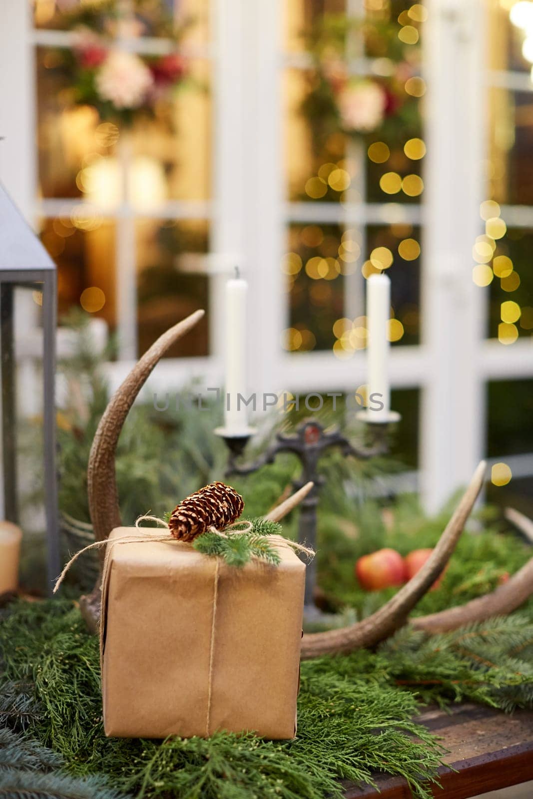 Home Christmas decoration interior late in night with light on xmas tree and gifts.