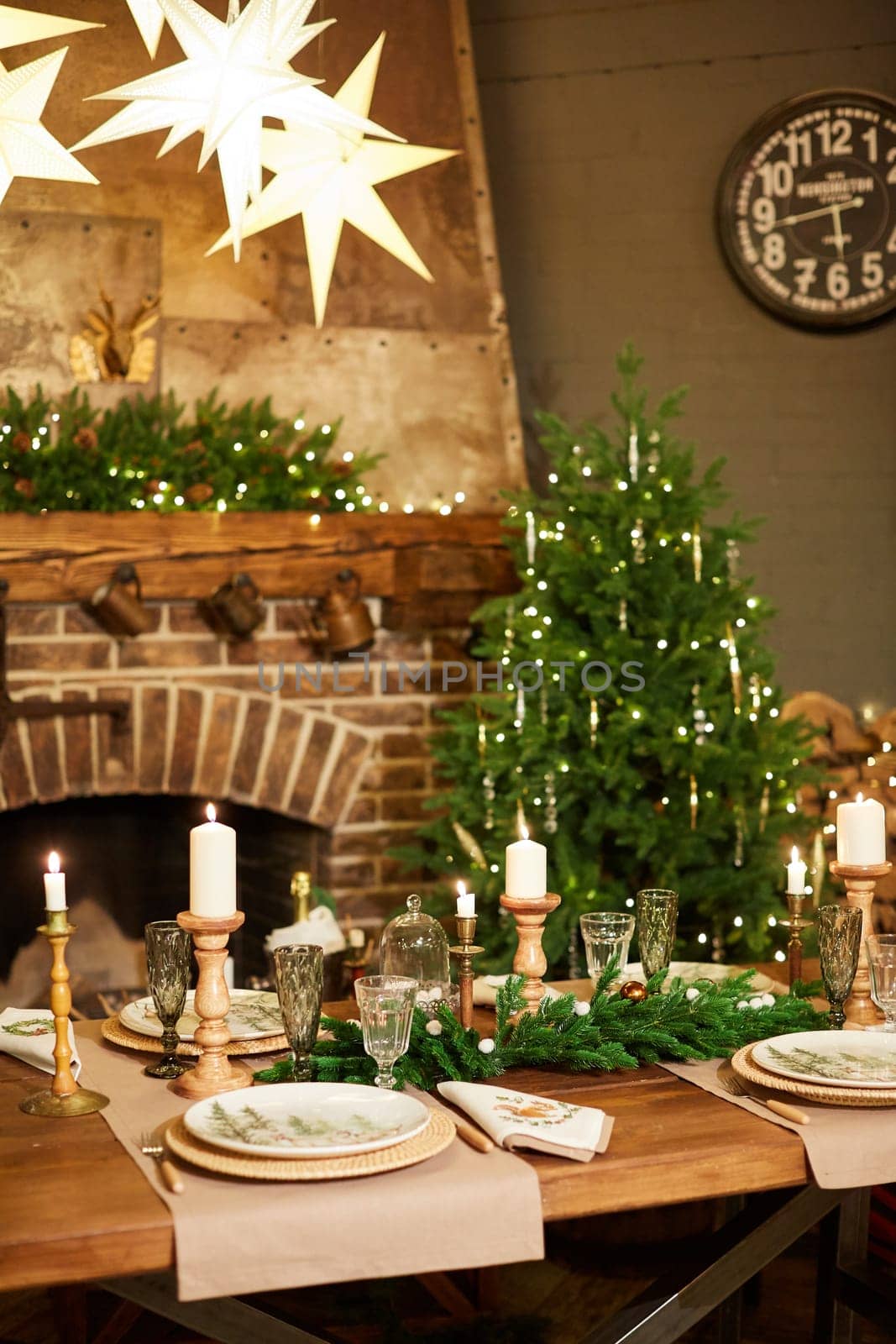Home Christmas decoration interior late in night with light on xmas tree and fireplace.