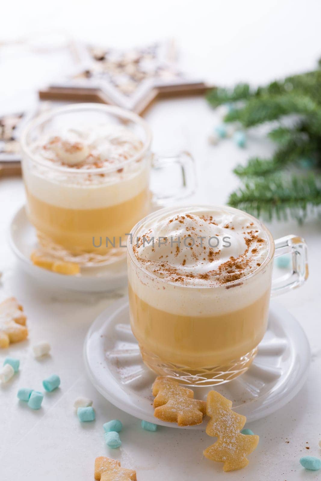 Eggnog with cinnamon and nutmeg with small tree cookies for Christmas and winter holidays.