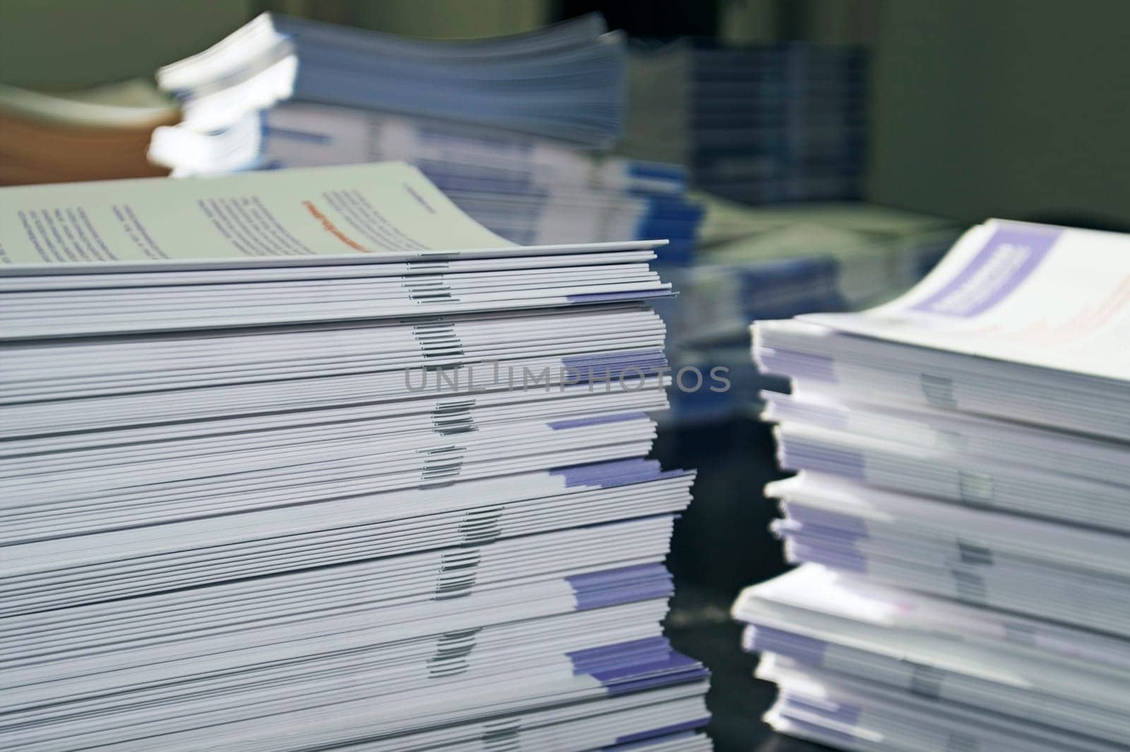 Piles of handout papers lying on table.