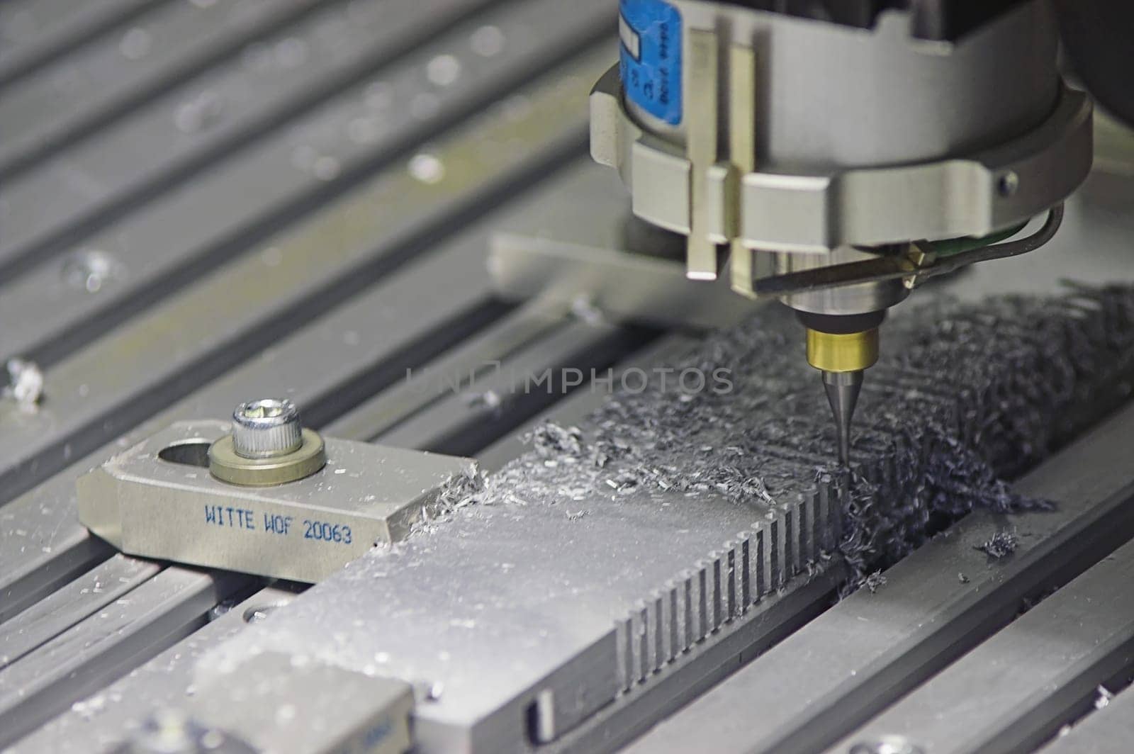 Drilling Machine automatically processing a metallic part.