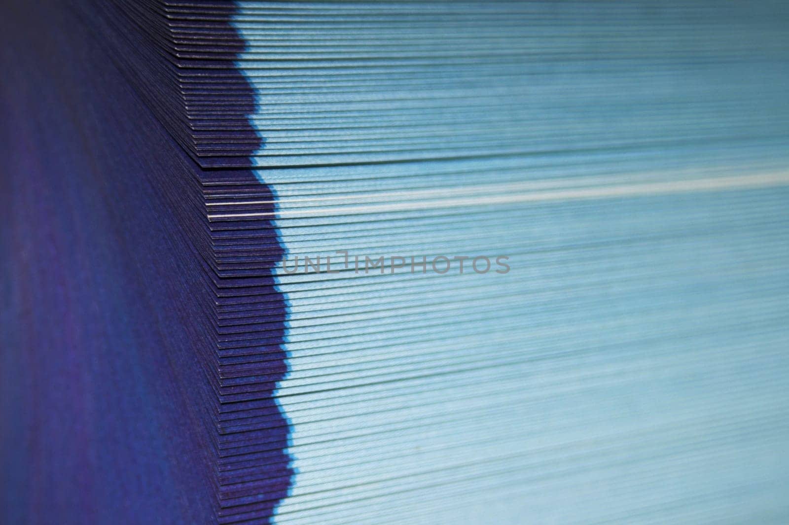 The cutting face of a phone directory with fanned pages.