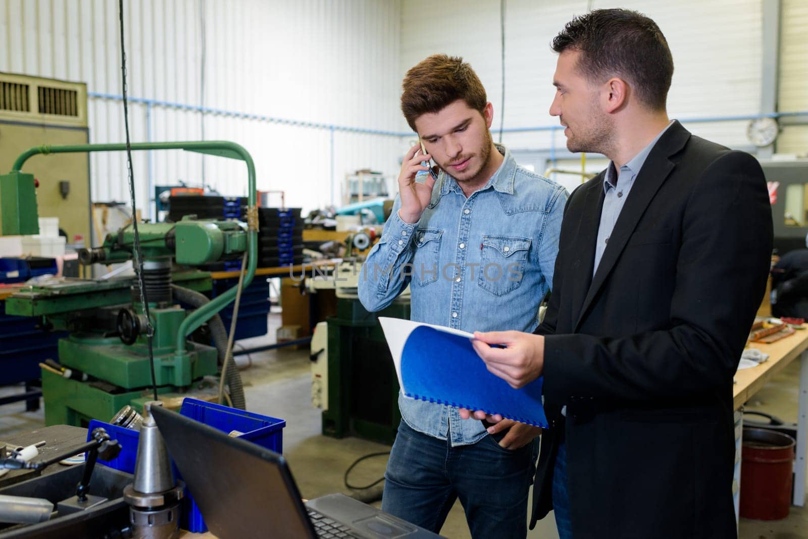 engineer and apprentice in factory