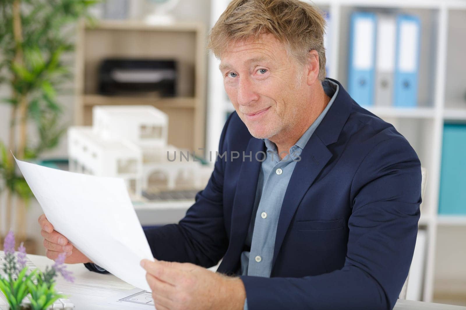 adult businessman in suit is laboring with concentration
