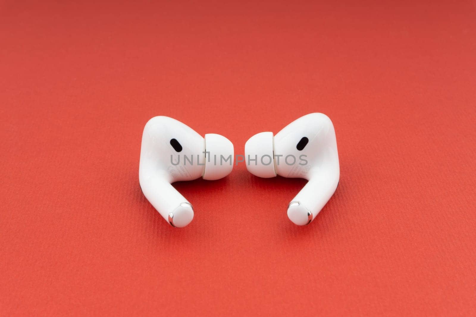 Kuala Lumpur, Malaysia - December 1,2020 : AirPods Pro on red background