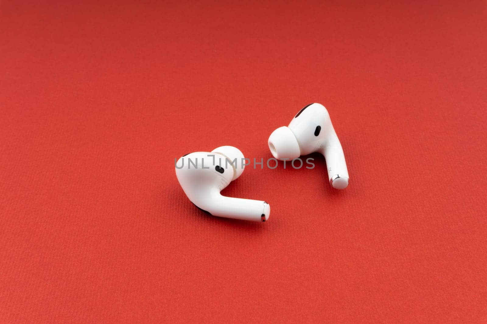 Kuala Lumpur, Malaysia - December 1,2020 : AirPods Pro on red background