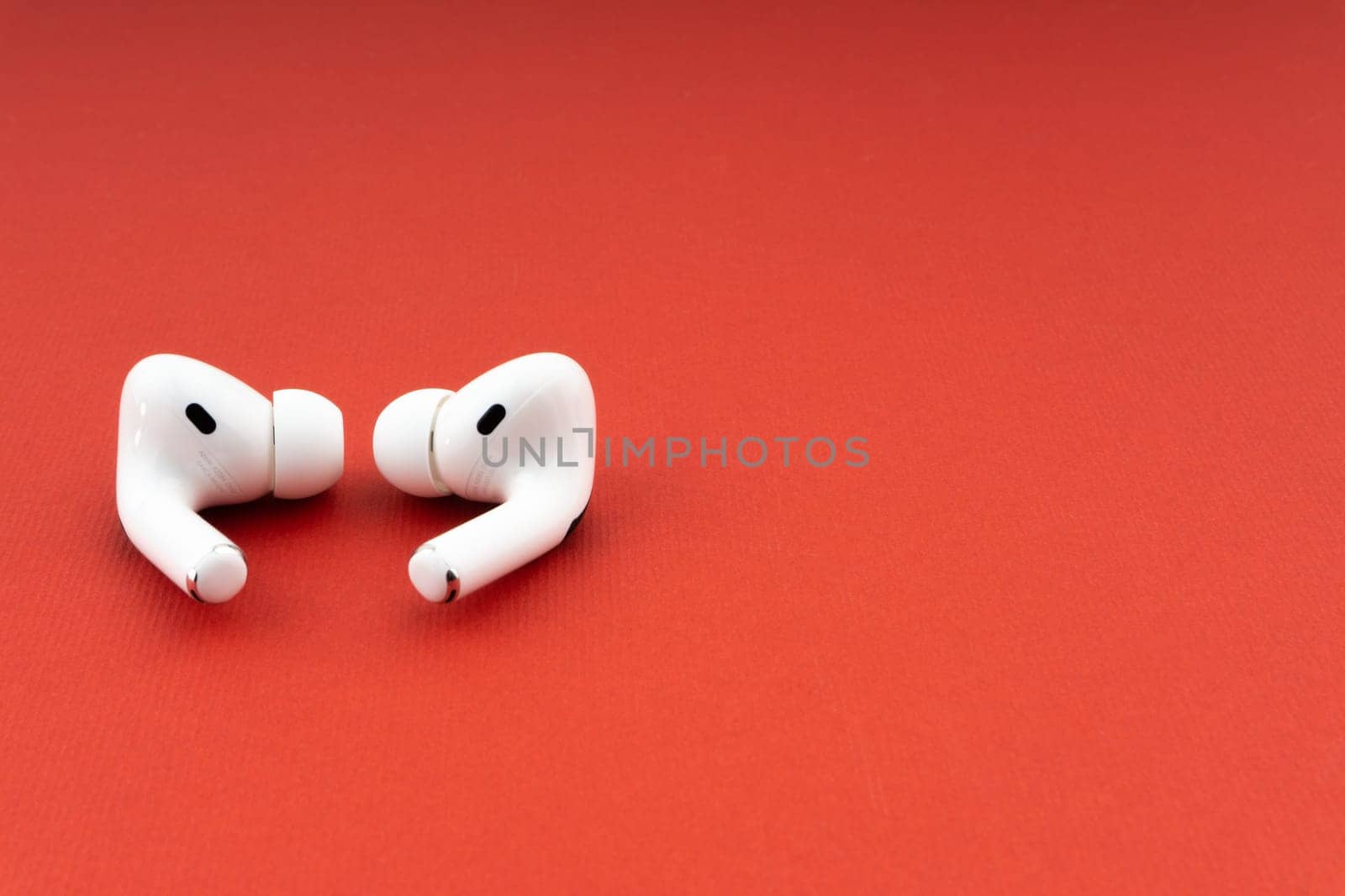 Kuala Lumpur, Malaysia - December 1,2020 : AirPods Pro on red background