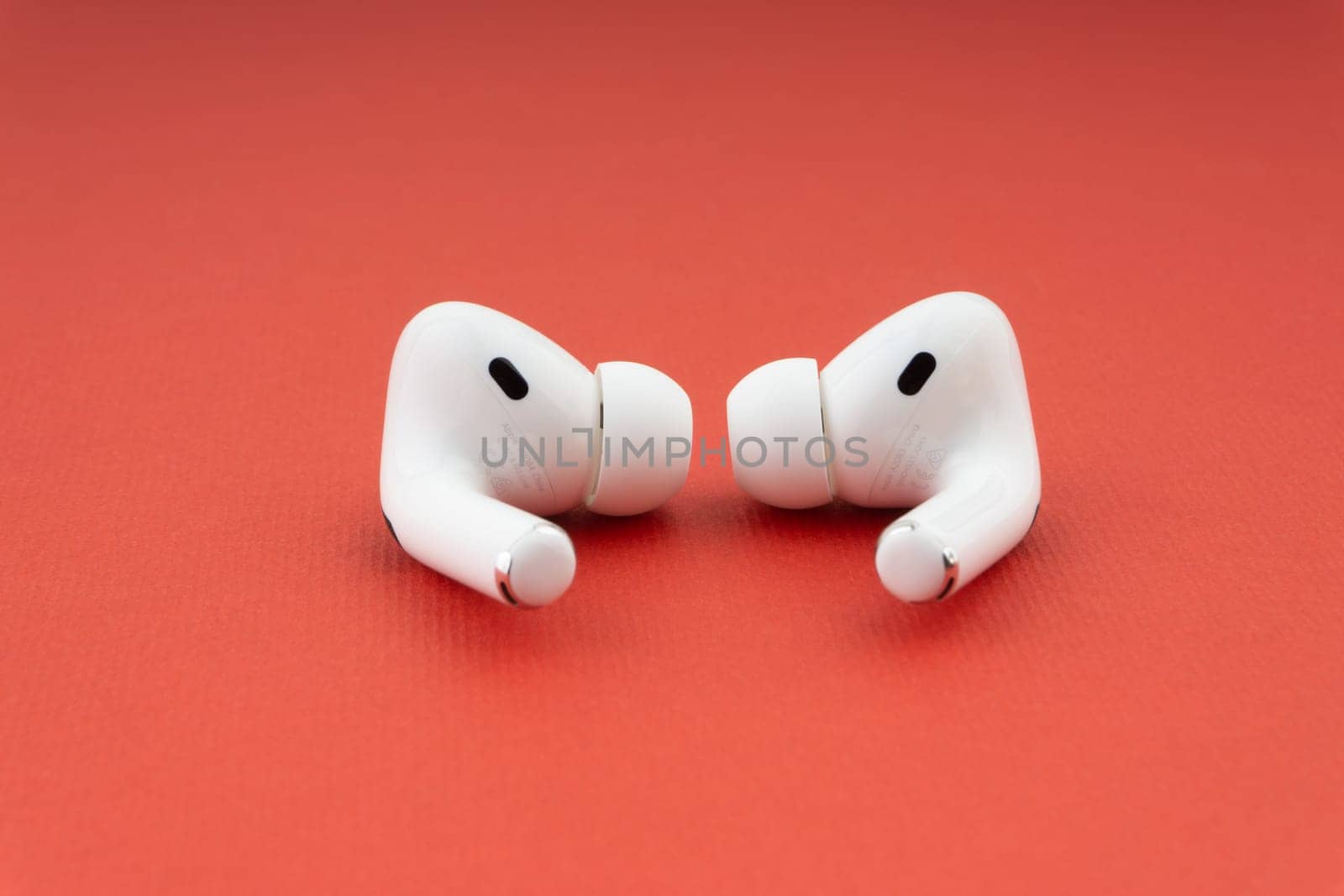 Kuala Lumpur, Malaysia - December 1,2020 : AirPods Pro on red background