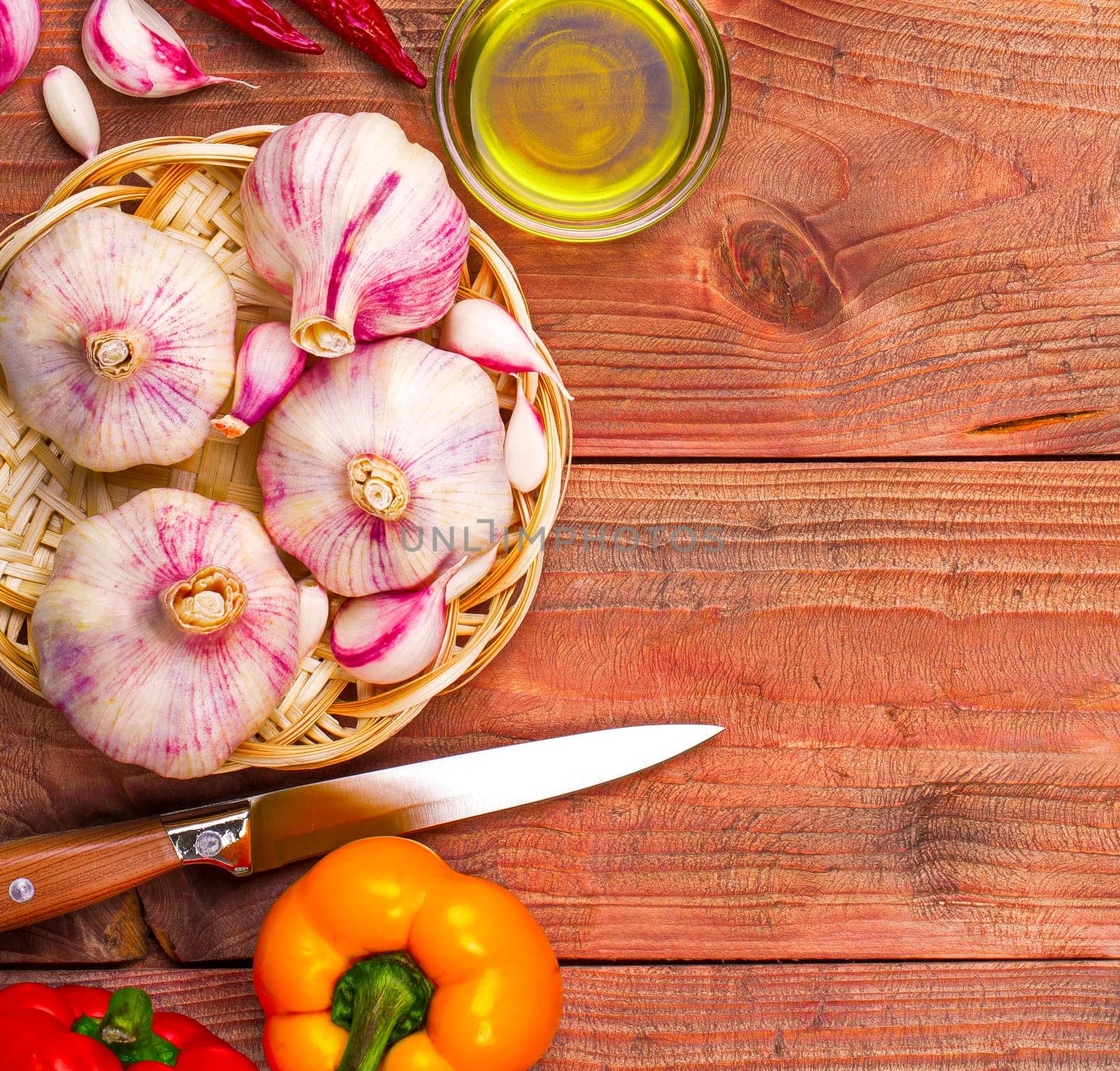 The Culinary background garlic, pepper on a wooden table