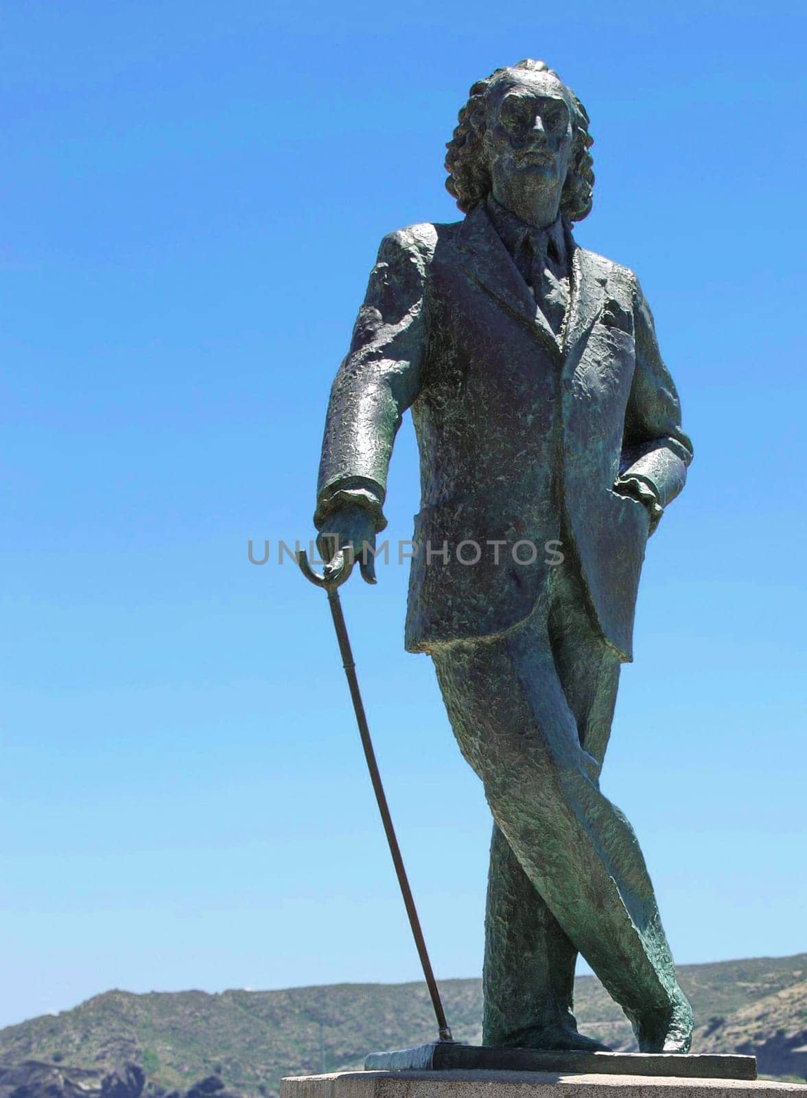 Cadaques, Spain - June 16, 2018: The bronze life-size statue to famous Salvador Dali in Spain