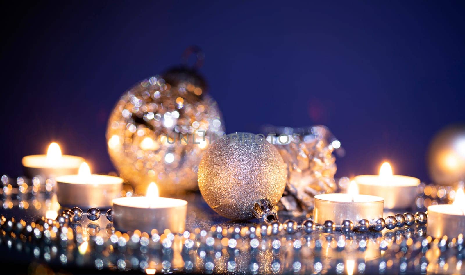 Silver Christmas balls over sparkling holiday background. Magic holiday lights. Merry Christmas and a Happy New Year