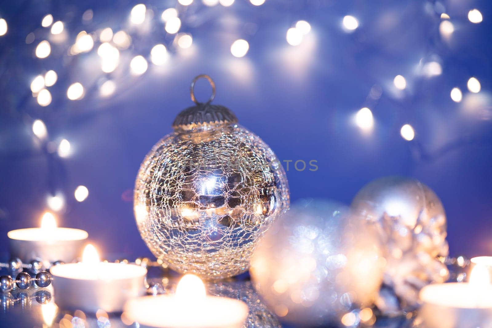 Silver Christmas balls over sparkling holiday background. Magic holiday lights. Merry Christmas and a Happy New Year