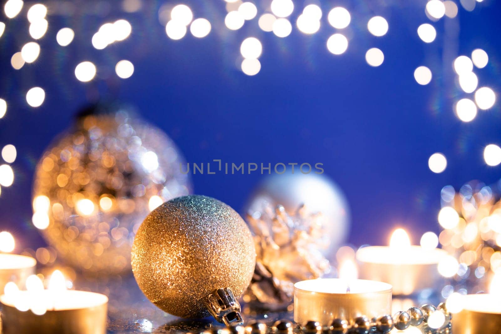 Silver Christmas balls over sparkling holiday background. Magic holiday lights. Merry Christmas and a Happy New Year