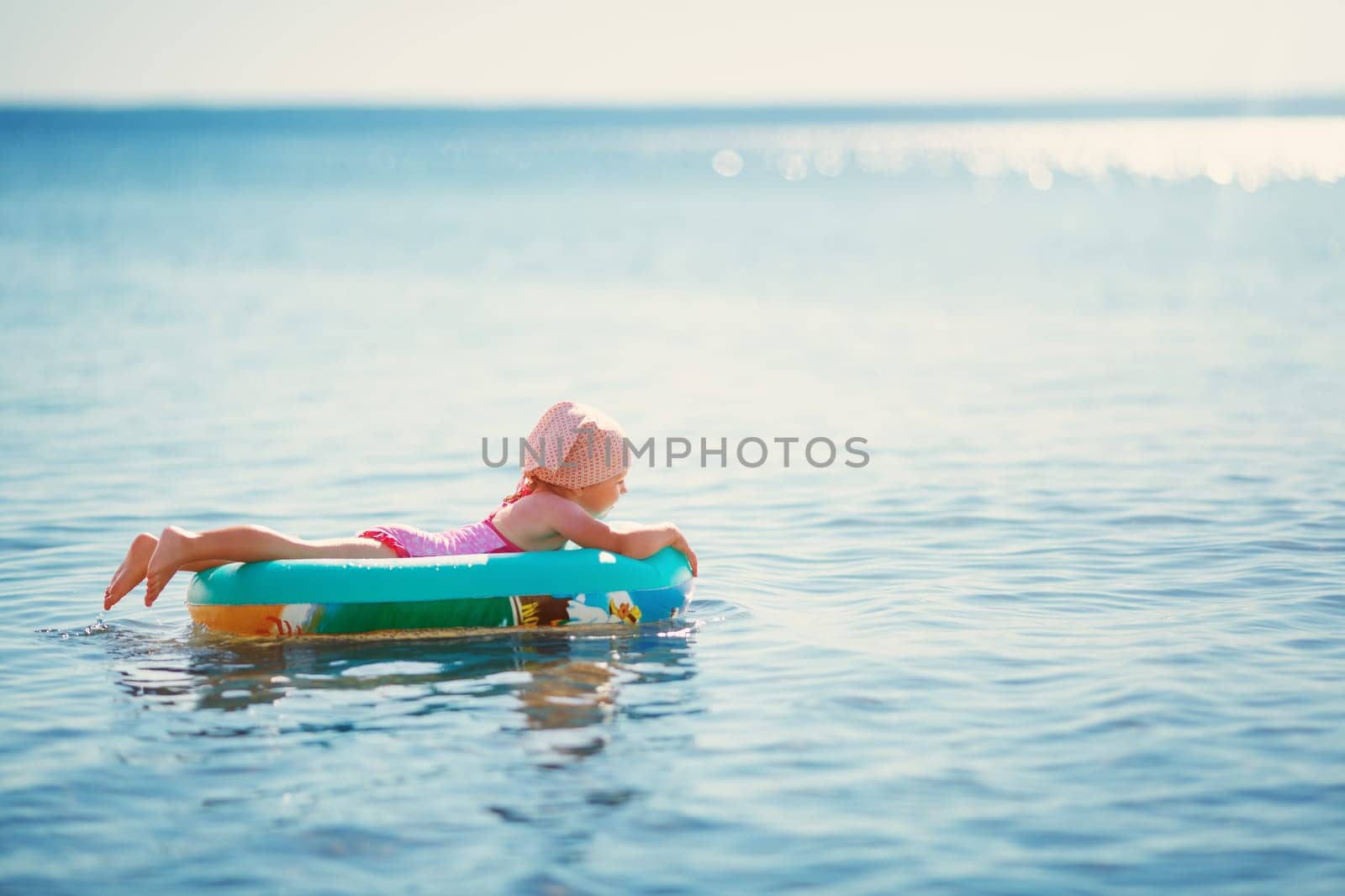three years old girl playing at the beach in boat. Child on family vacations at sea