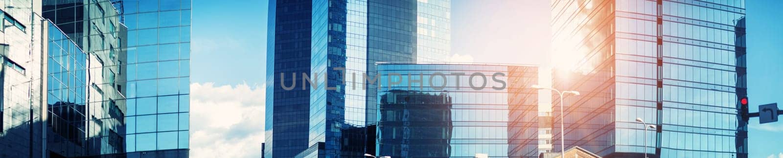Office buildings panorama with beautiful sunlight. Blue cityscape on sunny day
