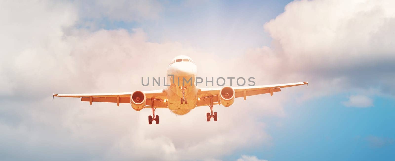 plane at landing on blue sky background with white clouds. Airplane turbine and wing view