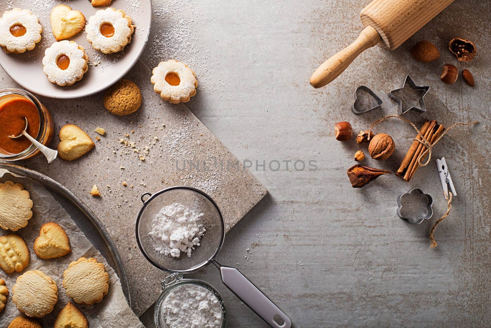 Making and baking cut-out sugar cookies of all shapes and sizes. Holiday, celebration and cooking concept.