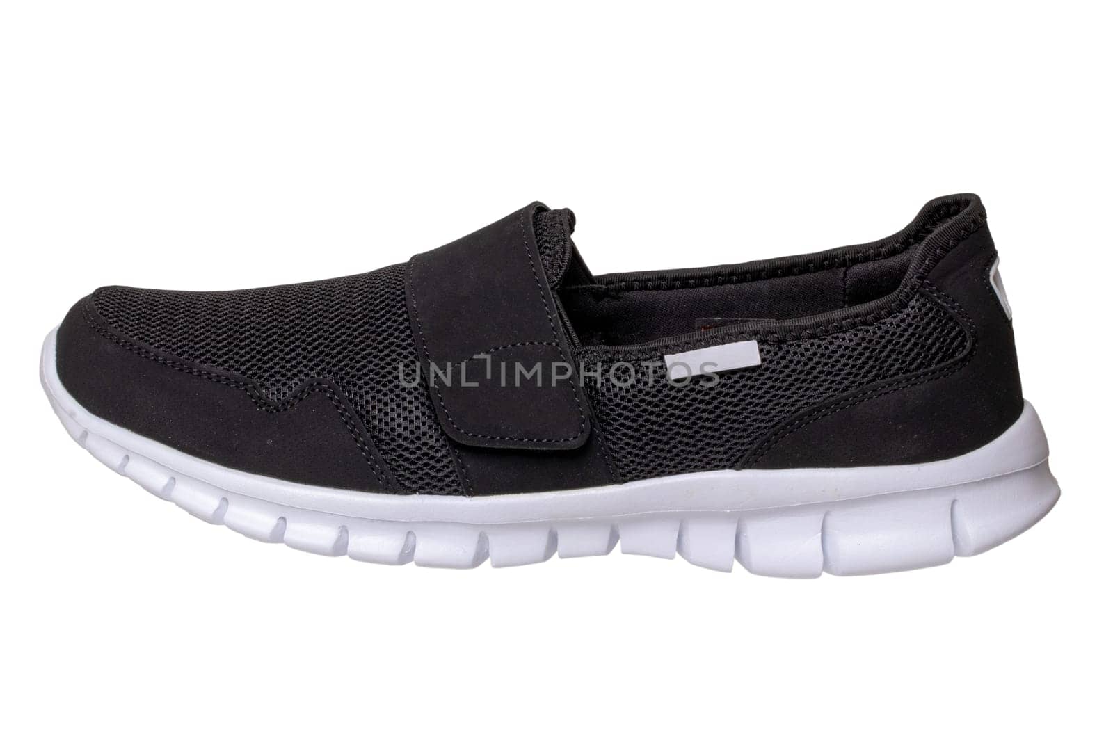 Mans black shoes. Close-up of a single black sneaker or sport shoe isolated on a white background. Clipping path included. Elegant and trendy mens footwear. Macro.