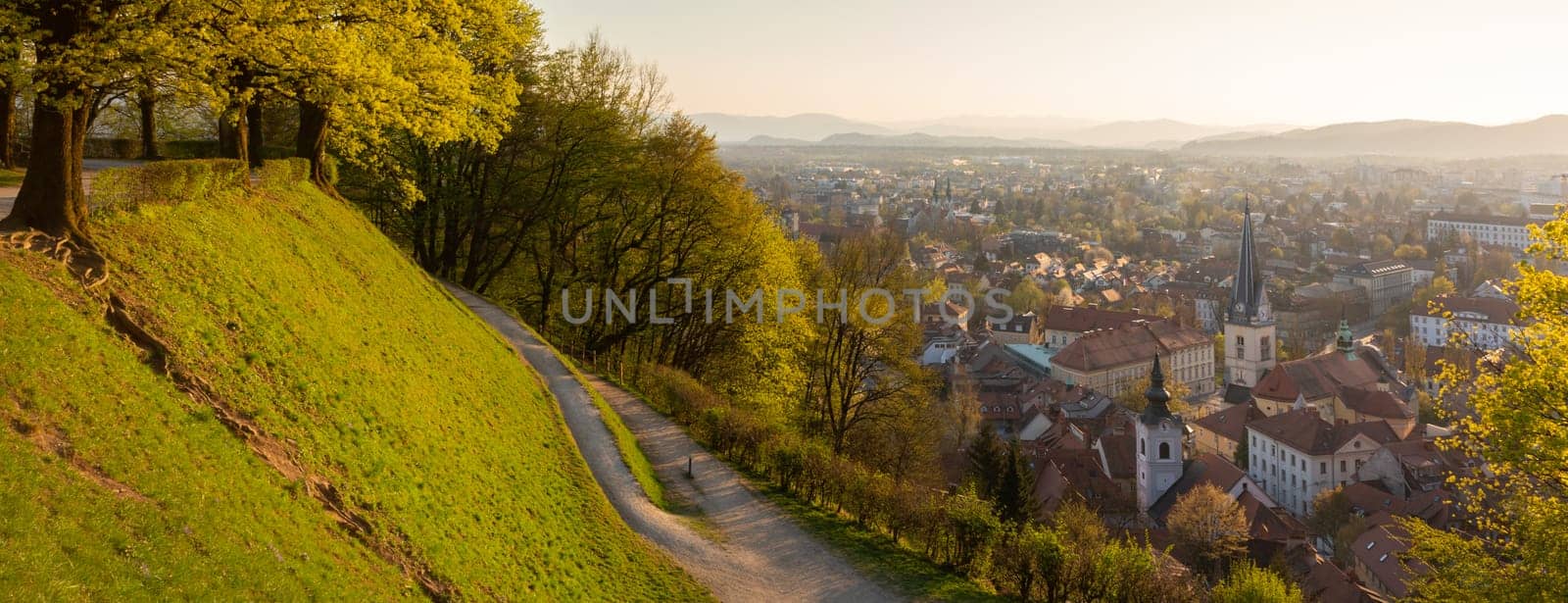 Panoramic view of Ljubljana, capital of Slovenia. Roooftops of Ljubljanas old medieval city center seen from Ljubljanas castle park at sunset.