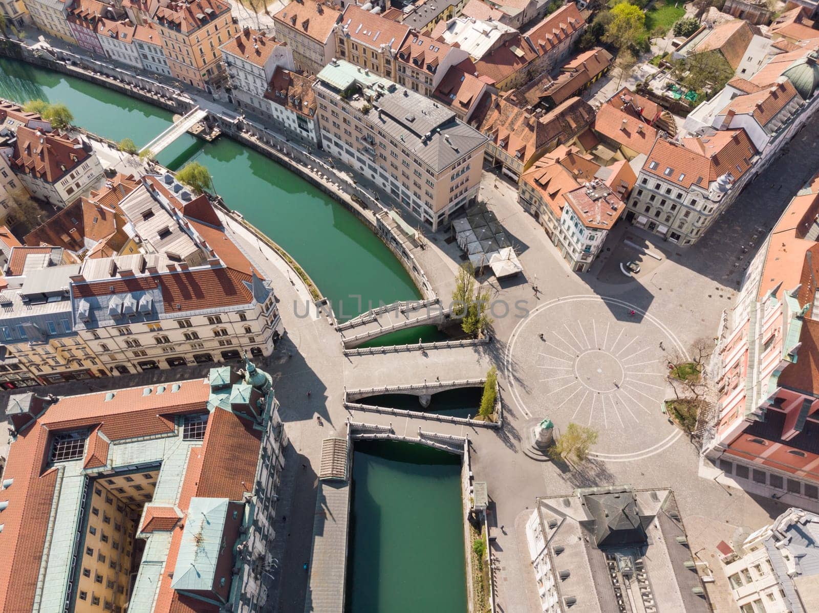Aerial drone view of Preseren Squere and Triple Bridge over Ljubljanica river,Tromostovje, Ljubljana, Slovenia. Empty streets during corona virus pandemic social distancing measures.