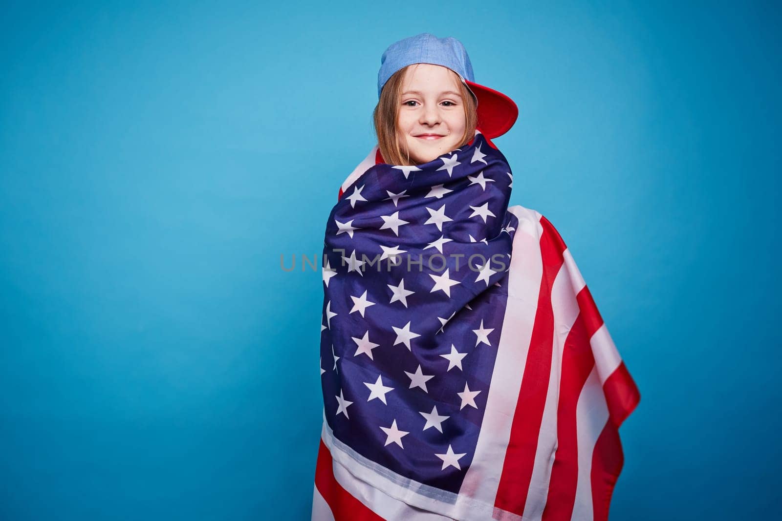 Cute girl wrapping in the American flag