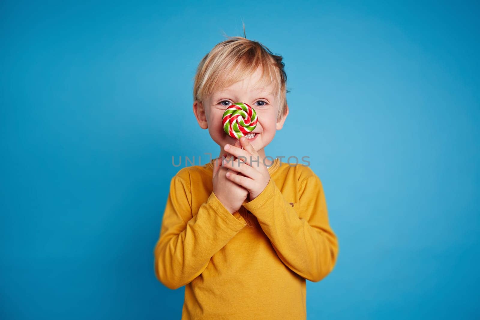 Cute little boy with lollipop