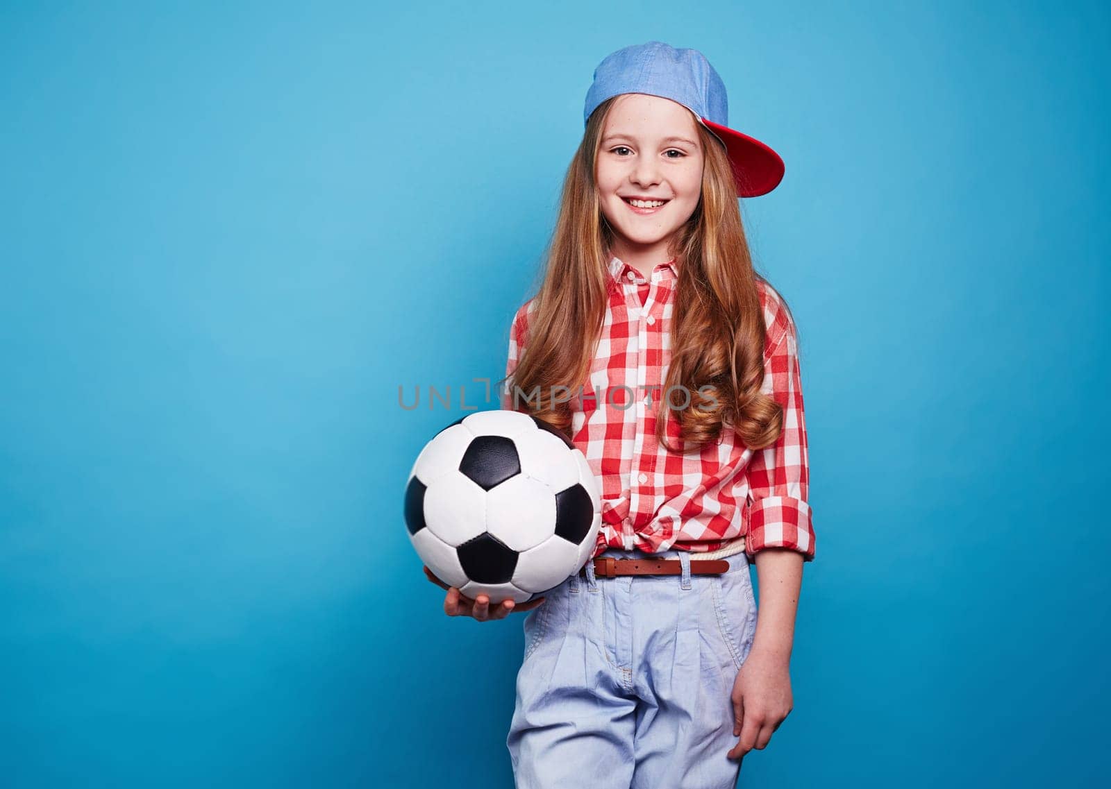 Smiling girl keeping white black ball