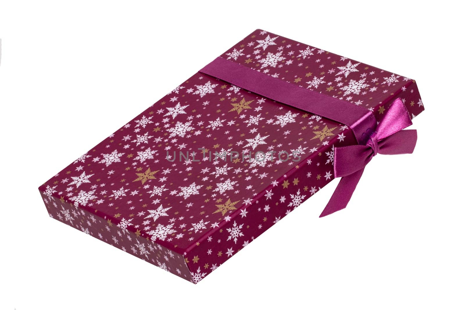 Gift box isolated. Close-up of a pink present or gift box with ribbon bow isolated on a white background. Birthday, valentine, anniversary or other holidays. Macro photograph.