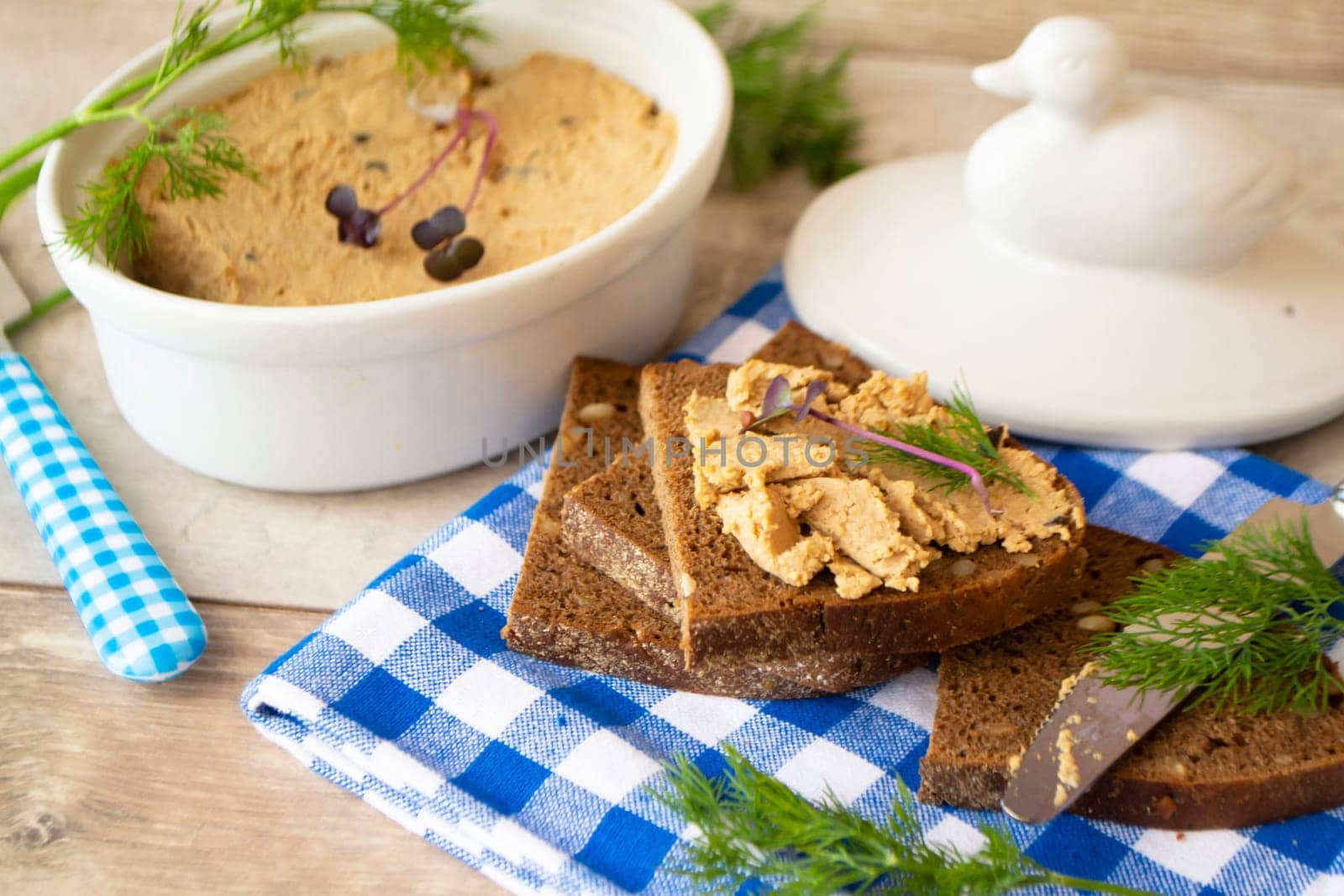 pate of liver and duck with slices of homemade bread on vintage style image