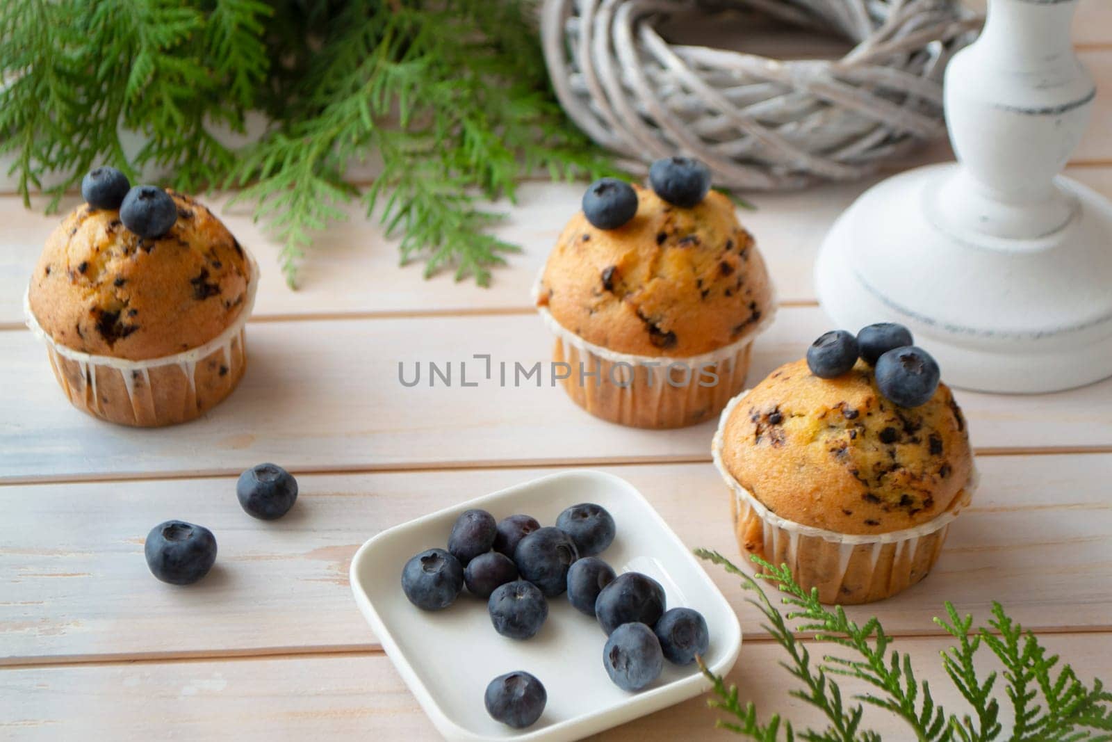 mascarpone and fresh blueberry muffins on white shabby wooden table
