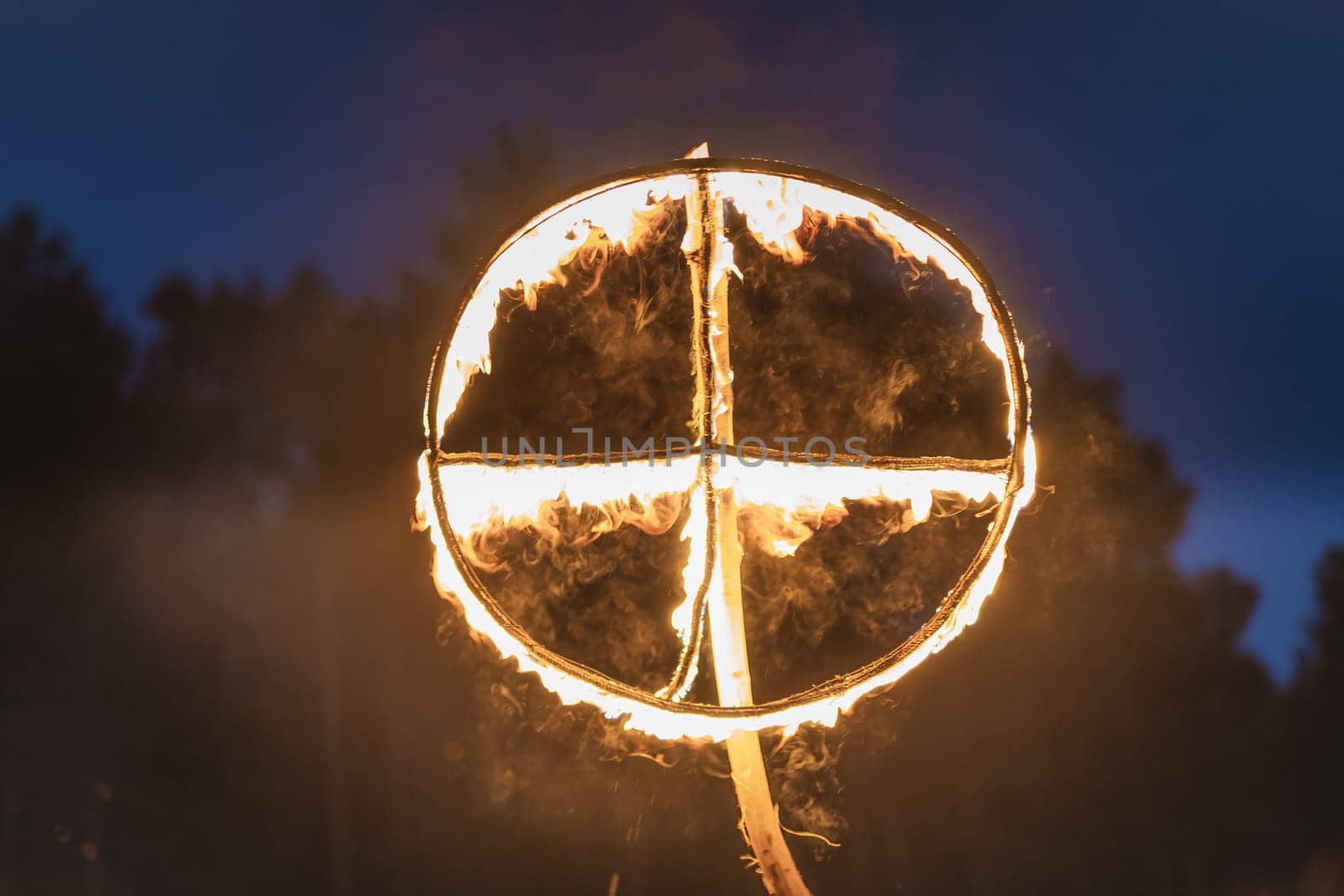 Burning symbol of the sun, a sun cross or solar wheel at pagan reenactment of Kupala Night, called in Poland Noc Kupaly. Slavic holiday celebrated on the shortest night of the year, summer solstice