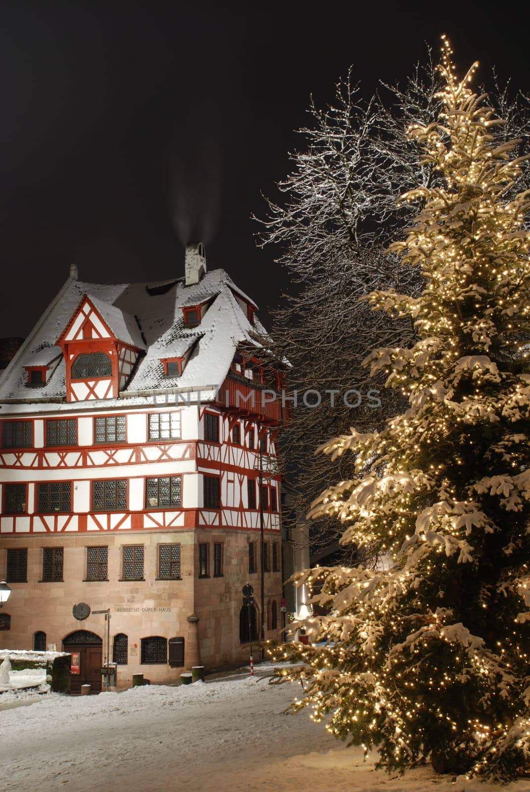 The historic Nuremberg Albrecht Dürer House on the Tiergärtnertorplatz at night during Christmas time and snowy