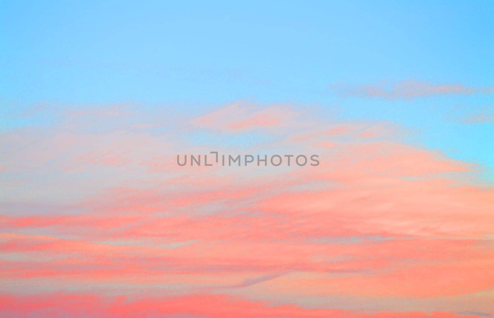 Colorful clouds on sunset sky, natural background in blue and pink or coral