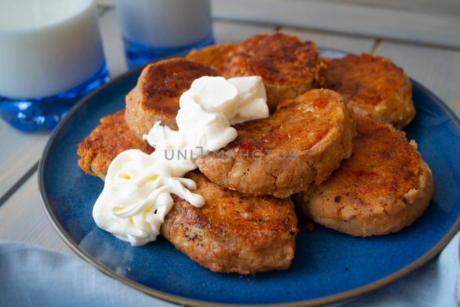 homemade delicious pancakes of buckwheat flour served with sour cream. Gourmet and healthy breakfast. backgound for Maslenitsa or Mardi gras