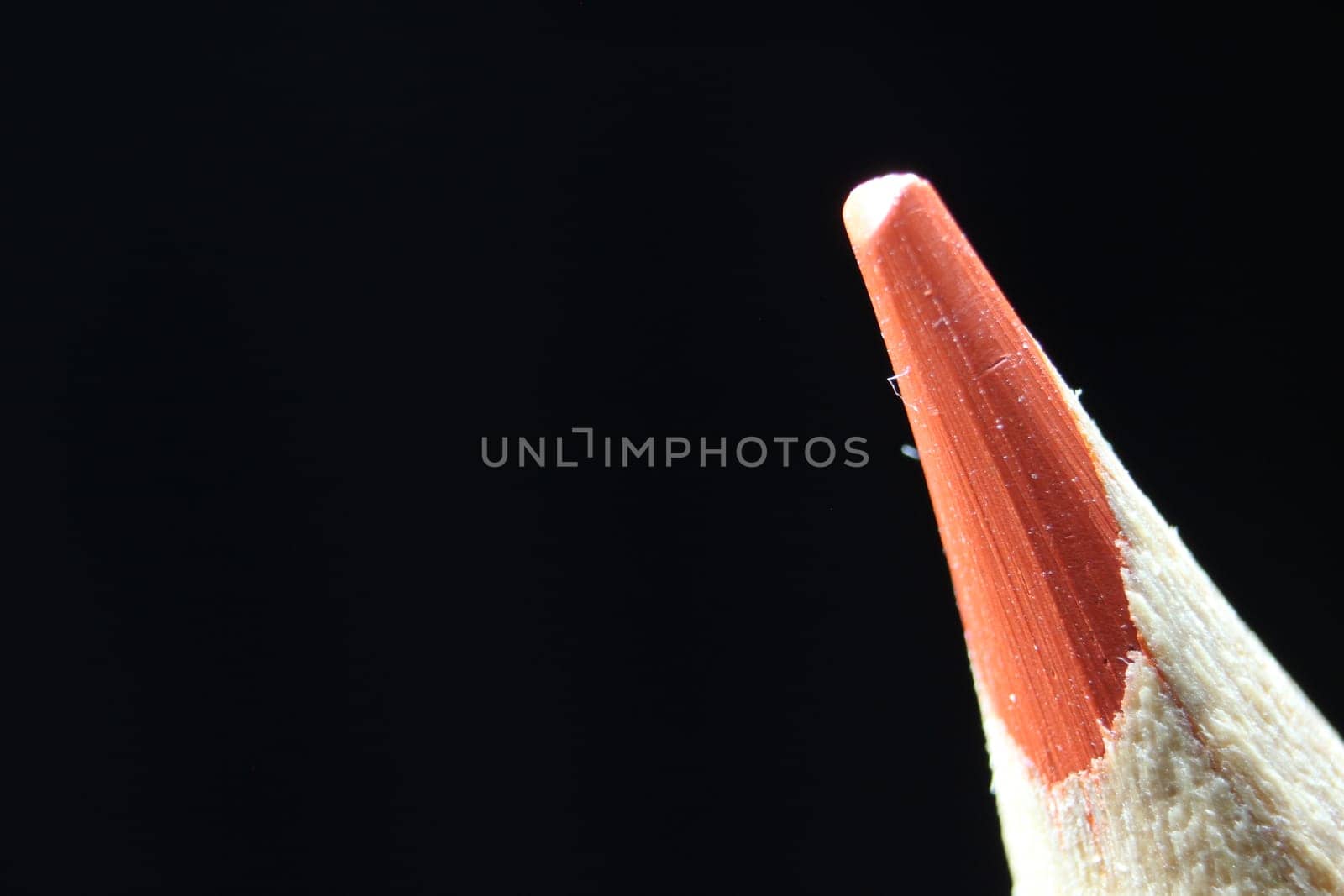 close up of sharpened pencil.Macro view of the tip of the pencil on a black background.