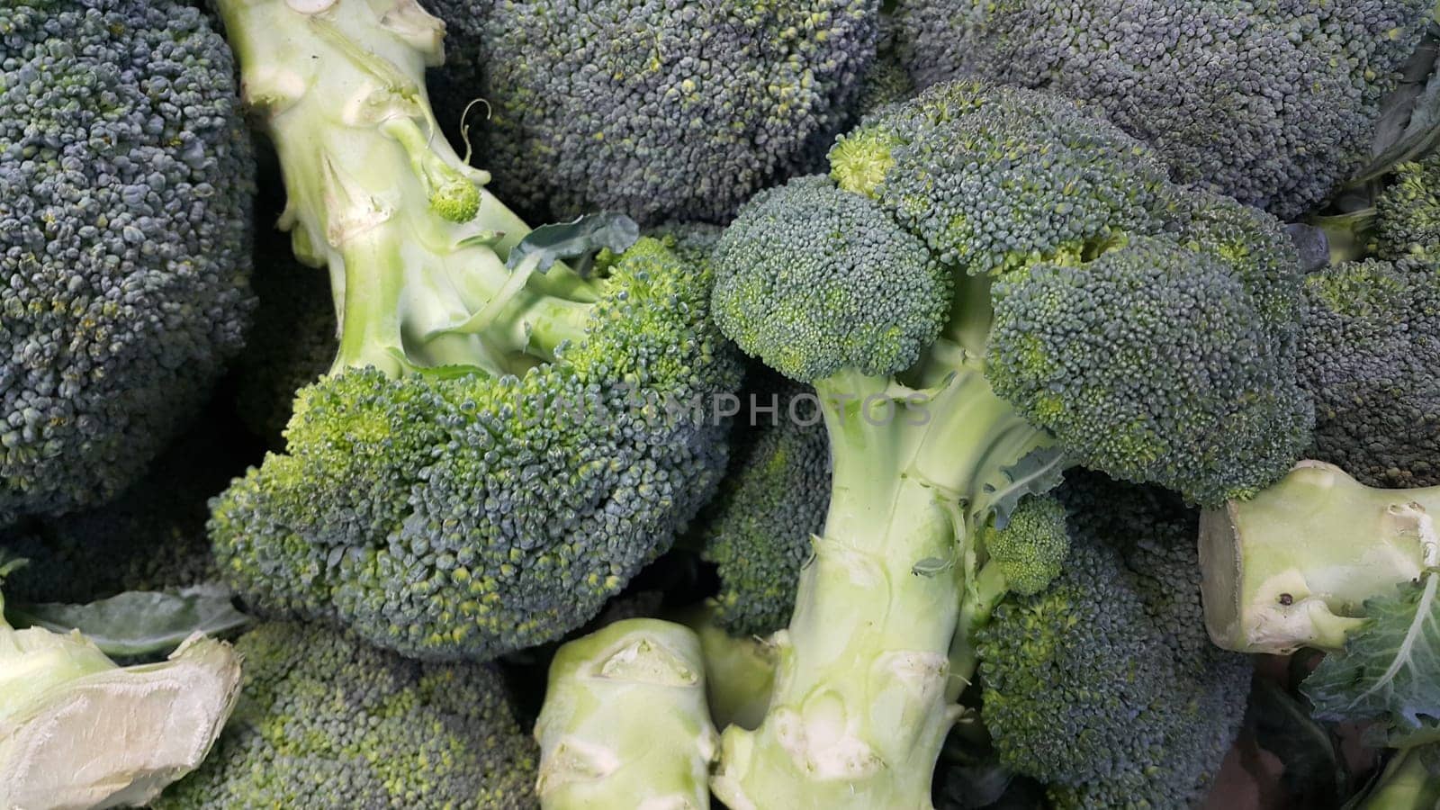 Green fresh broccoli pile placed in market for sale. A Close up top view