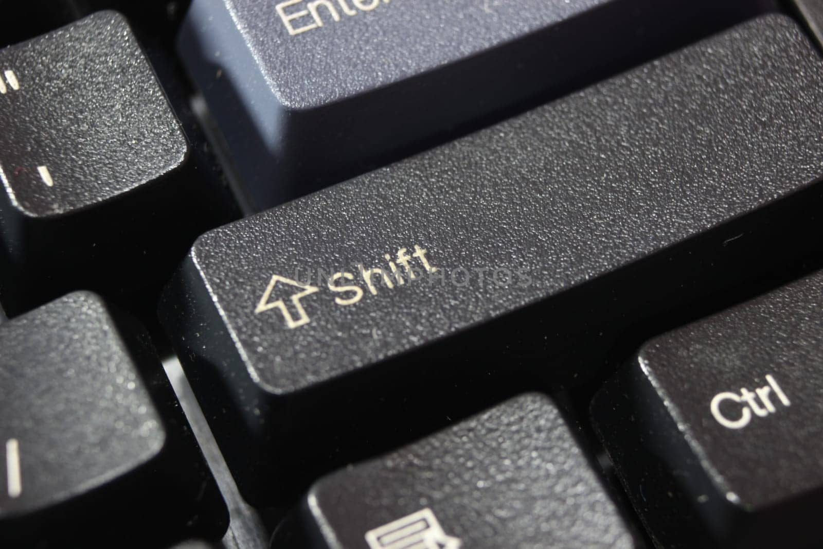 Closeup of laptop computer keyboard black keys with white letters and numbers. Black keys with white characters.