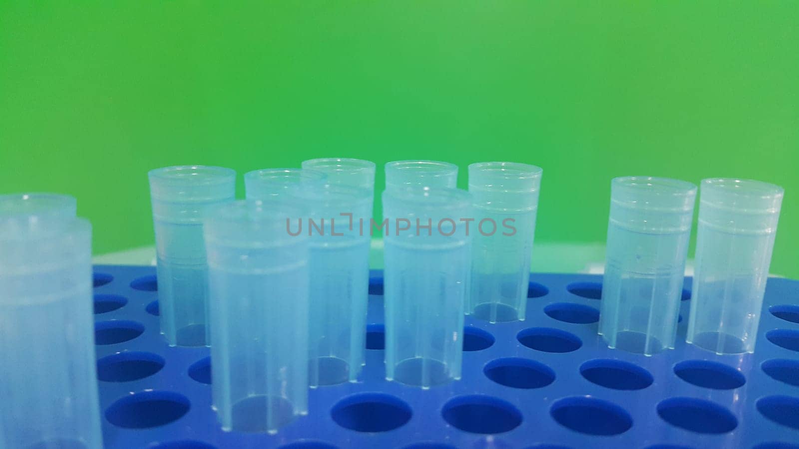 Close up view of blue micro litre tips in microtip box with empty holes. Reseach lab. tool for accurate measurement.
