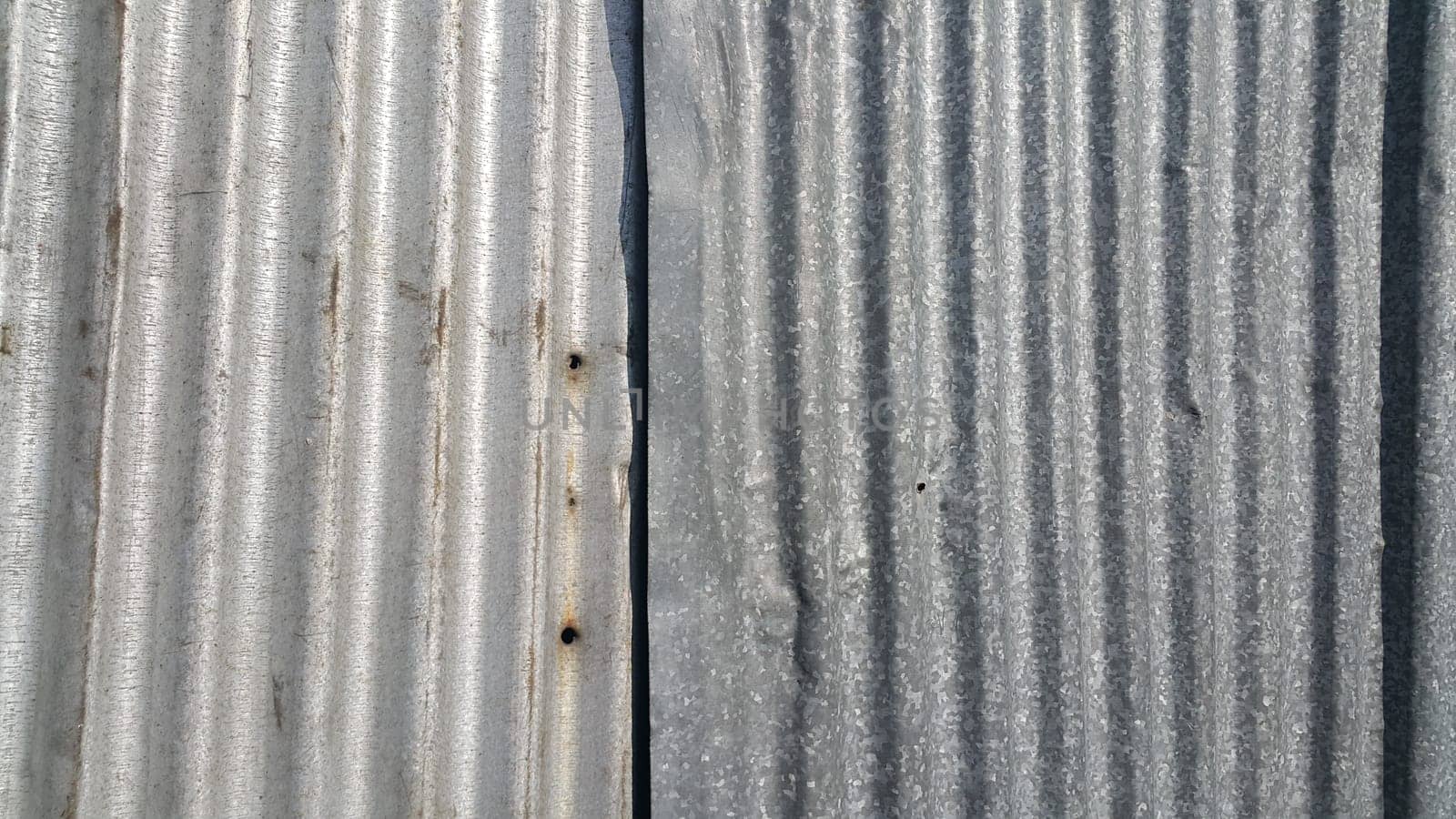 Silver corrugated metal sheet texture background. Steel metal cinc galvanized wave metal sheet for roof and walls.