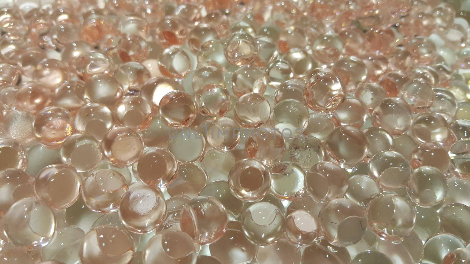 Closeup view with selective focus of shiny glittering orbeez or colorful water balls hydrogel. Water beads orbeez background.
