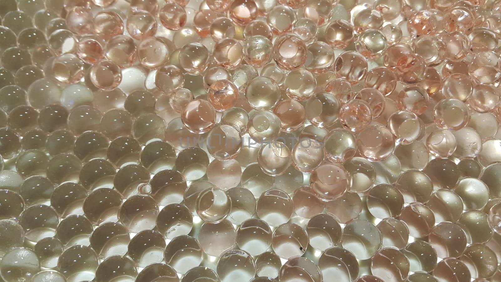 Closeup view with selective focus of shiny glittering orbeez or colorful water balls hydrogel. Water beads orbeez background.