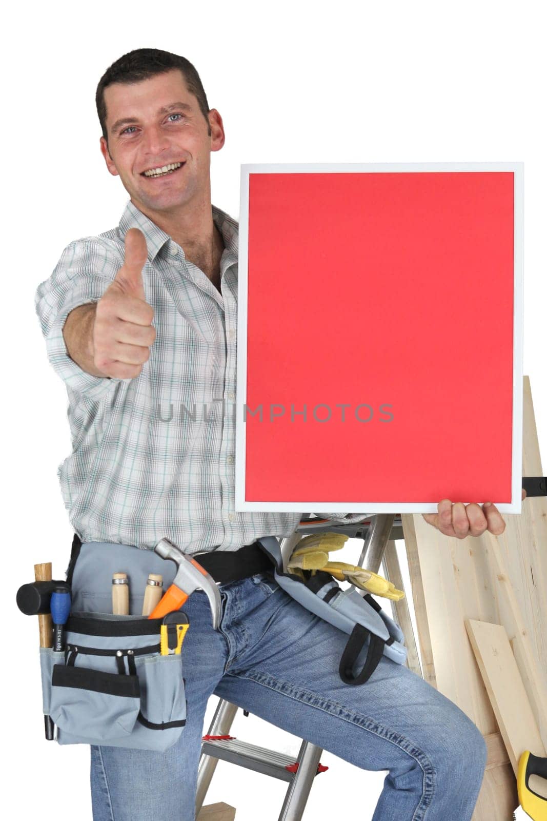 Carpenter stood by ladder giving the thumbs-up