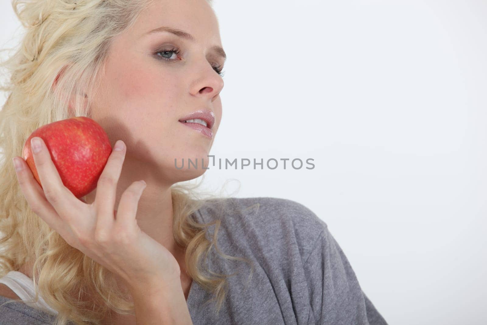 Attractive blond holding red apple
