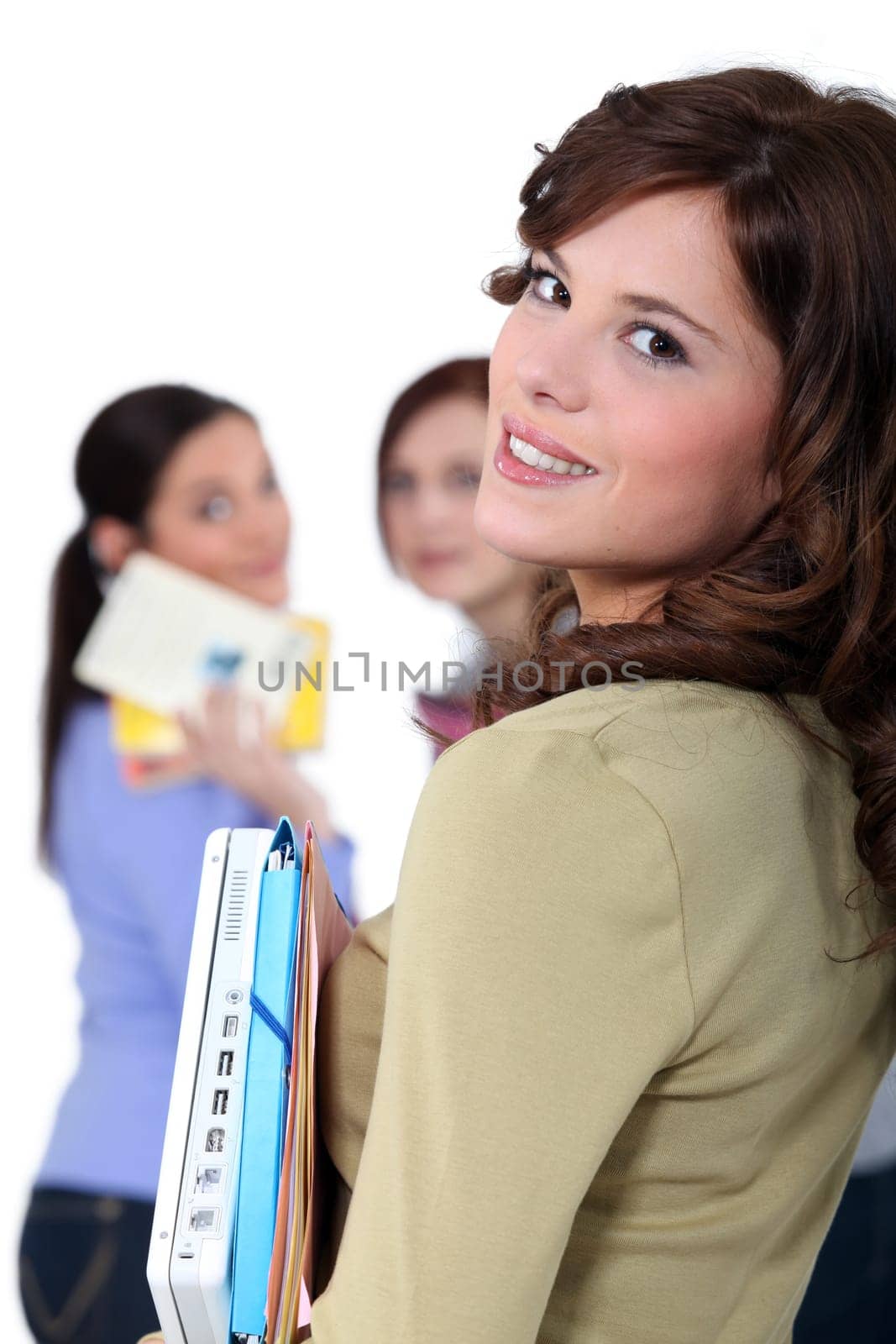 Students carrying files and laptops
