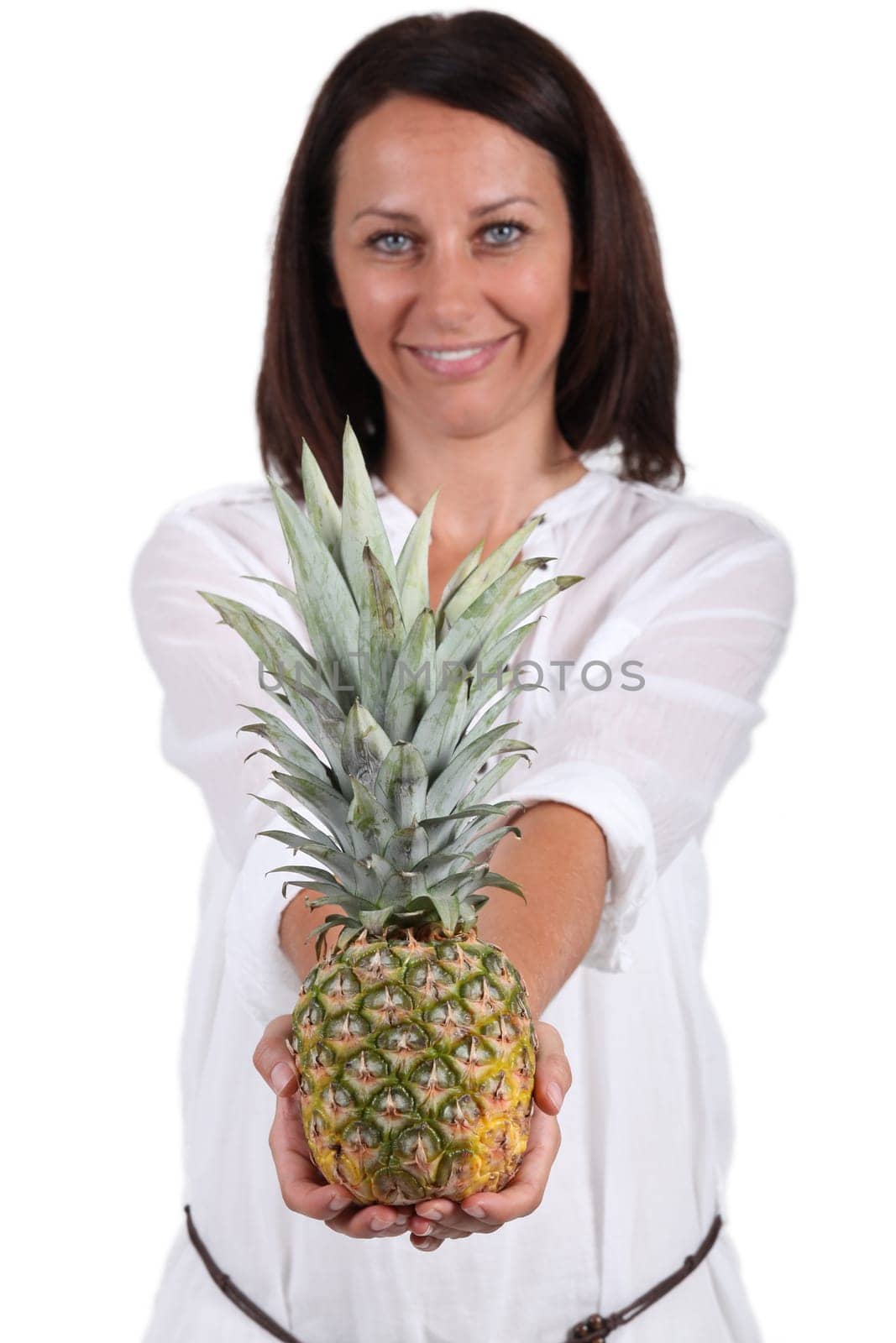 Smiling woman showing pineapple
