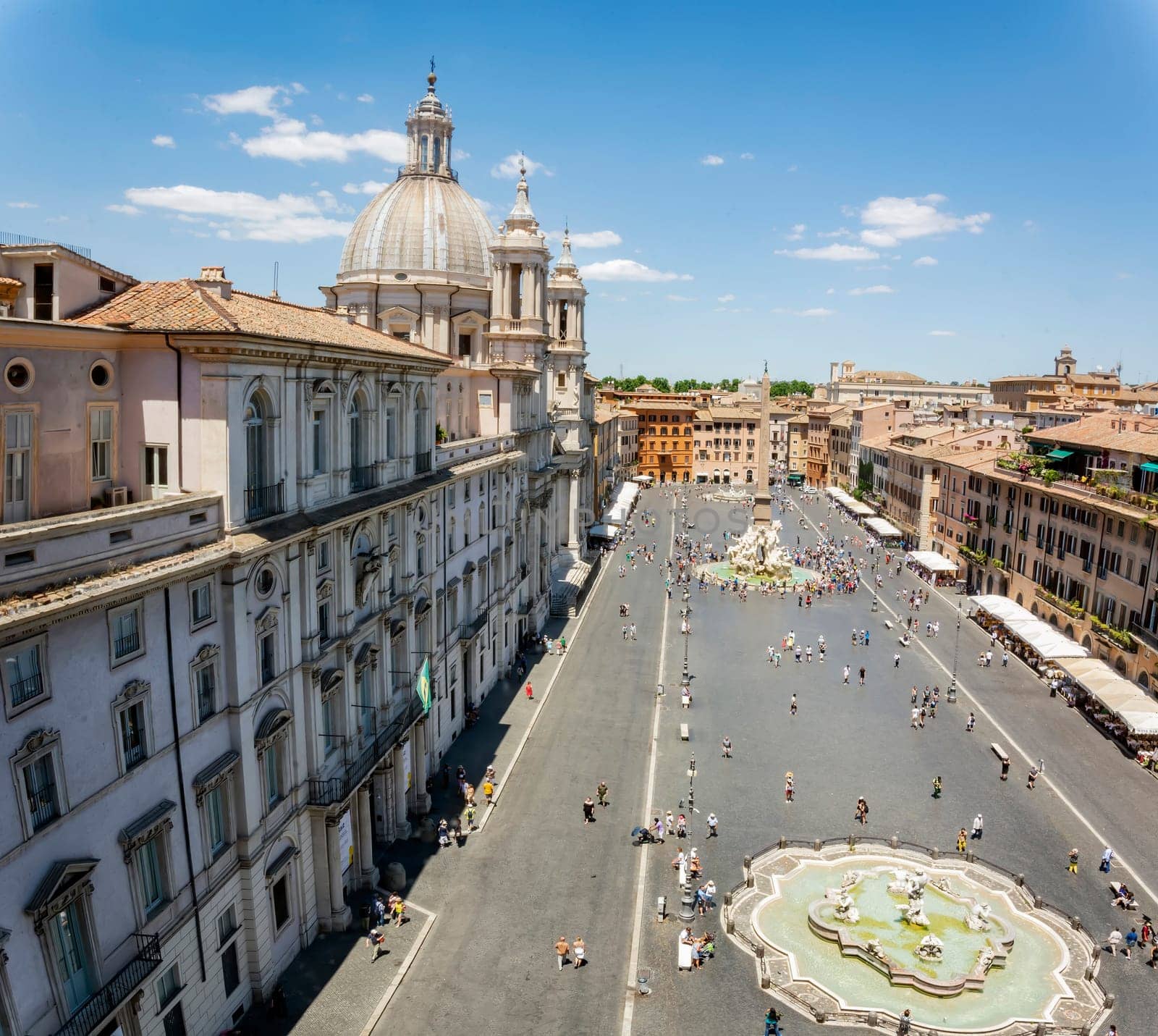 Top view of Piazza Navona in Rome with a crowd of unrecognizable tourists on a sunny day. Tourism and travel. Famous tourist destination. Baroque art