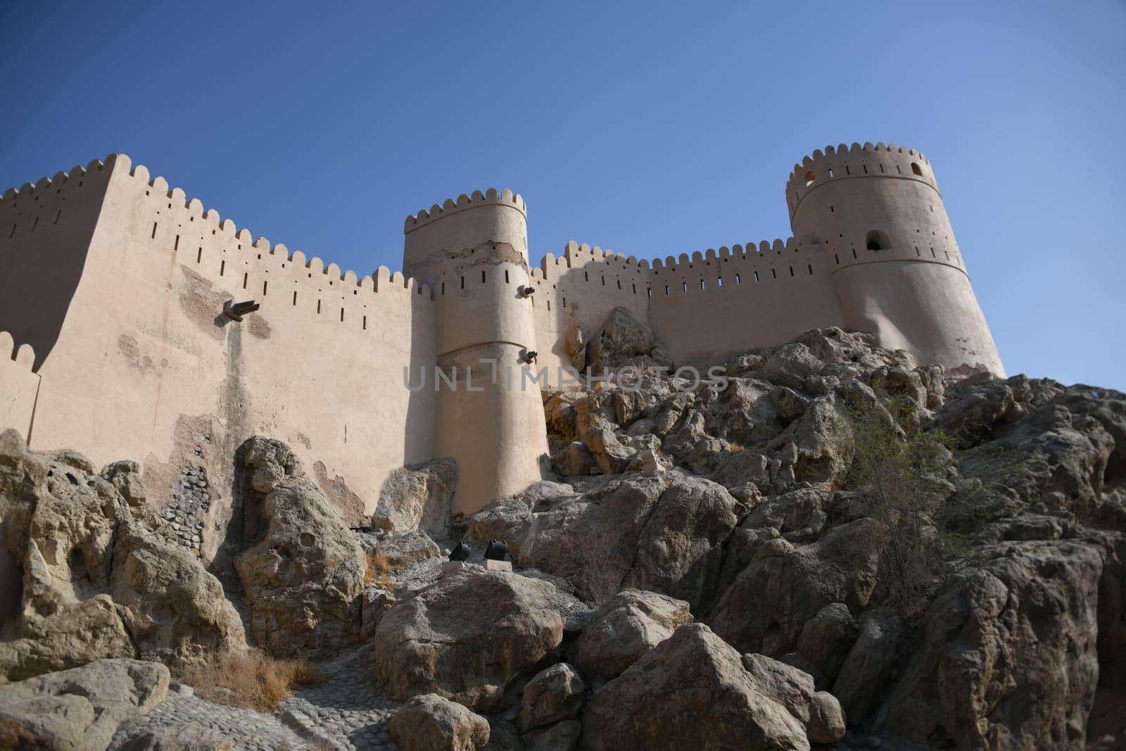 The Nakhal Nakhl Fort is a large fortress at the foot of the Hadshar Mountains in the Al Batinah region of Oman.