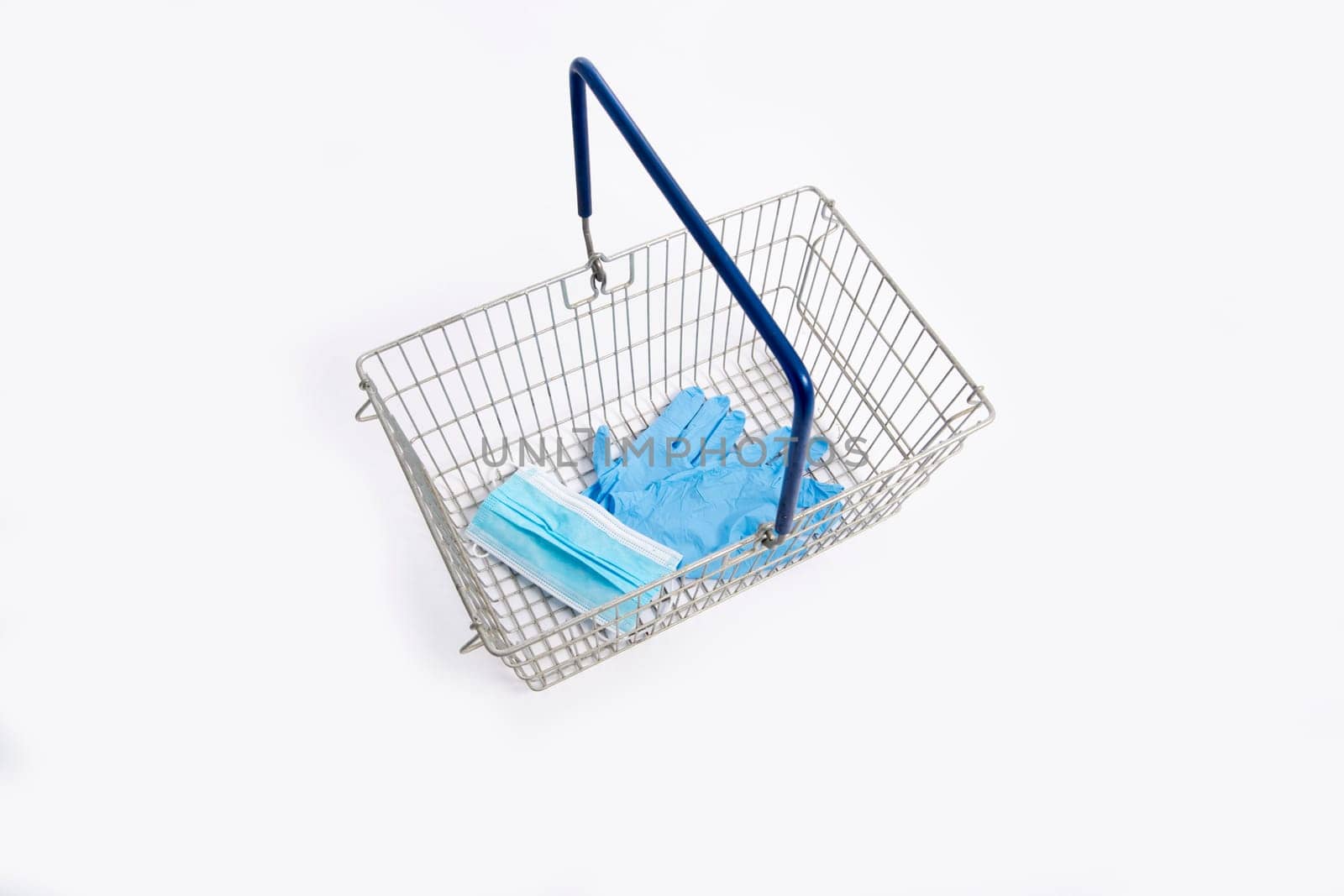 Shopping basket with hand gloves and mouth mask, isolated on white background
