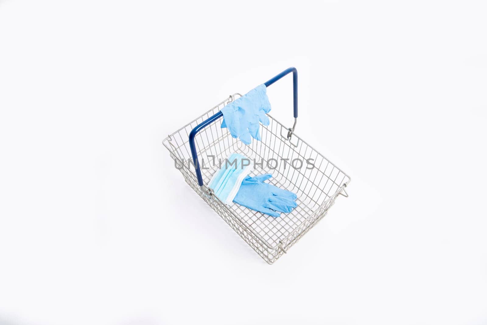 Shopping basket with hand gloves and mouth mask, isolated on white background